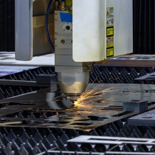 CNC laser cutting machine precision metal fabrication technology modern industry, High precision CNC laser cutting machine industrial metal sheet fabrication with spark.